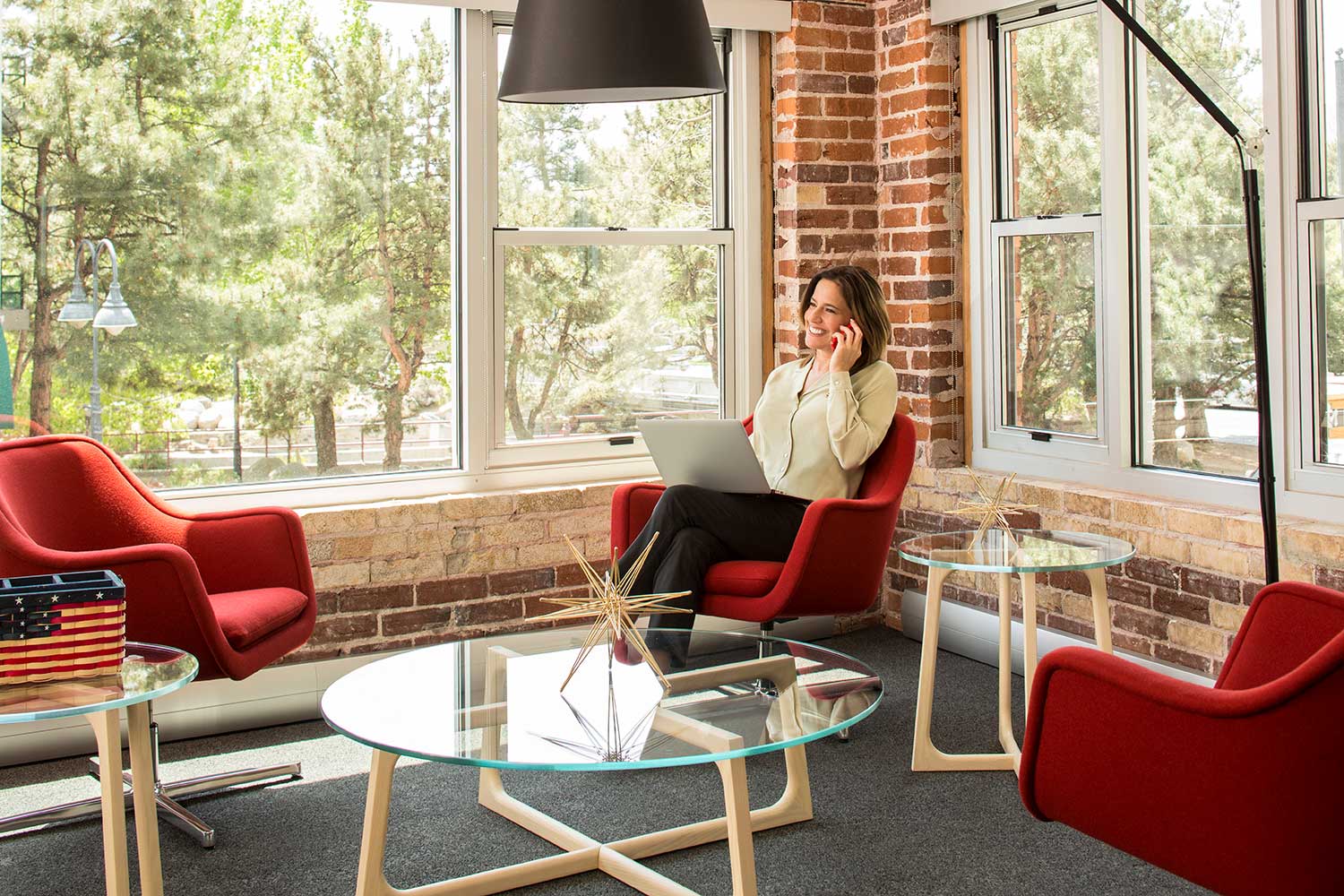 Woman on the phone sits in a chic office