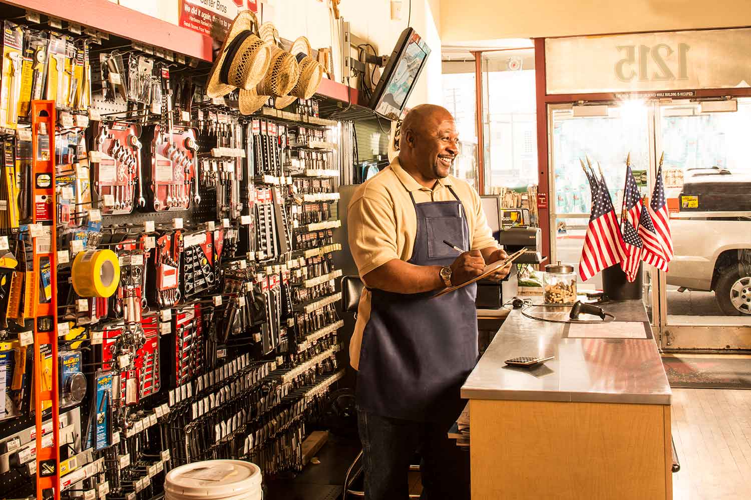 Man stands behind counter of a hardware store