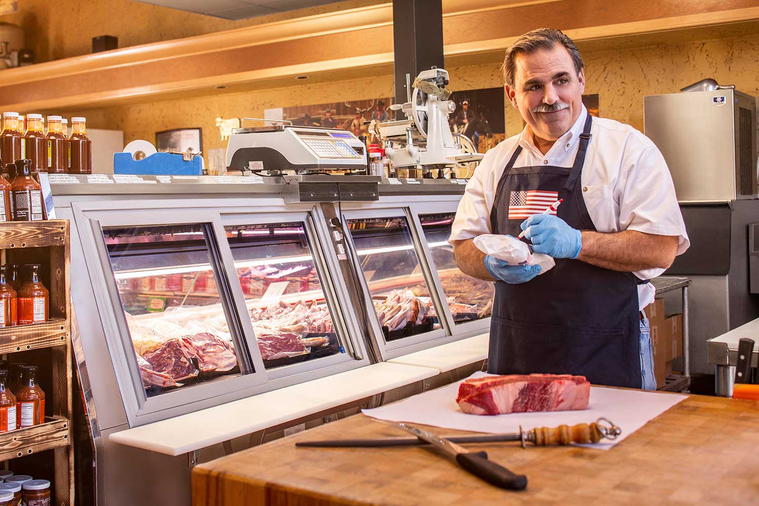 Butcher wrapping meat in his shop