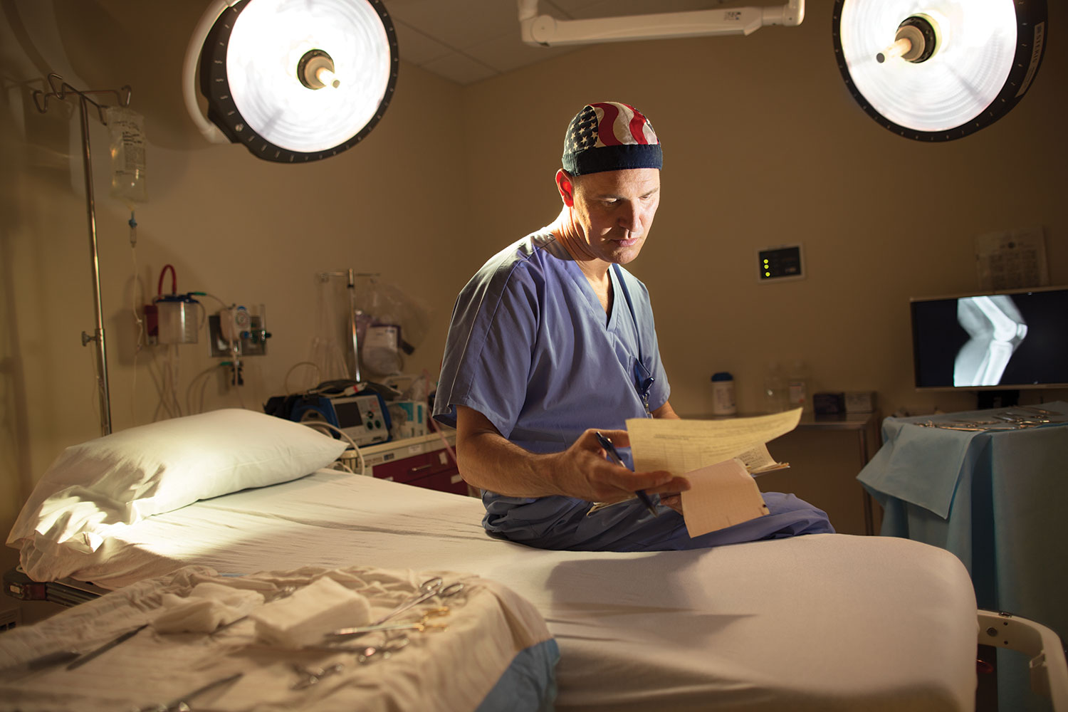 Surgeon sits and examines a file