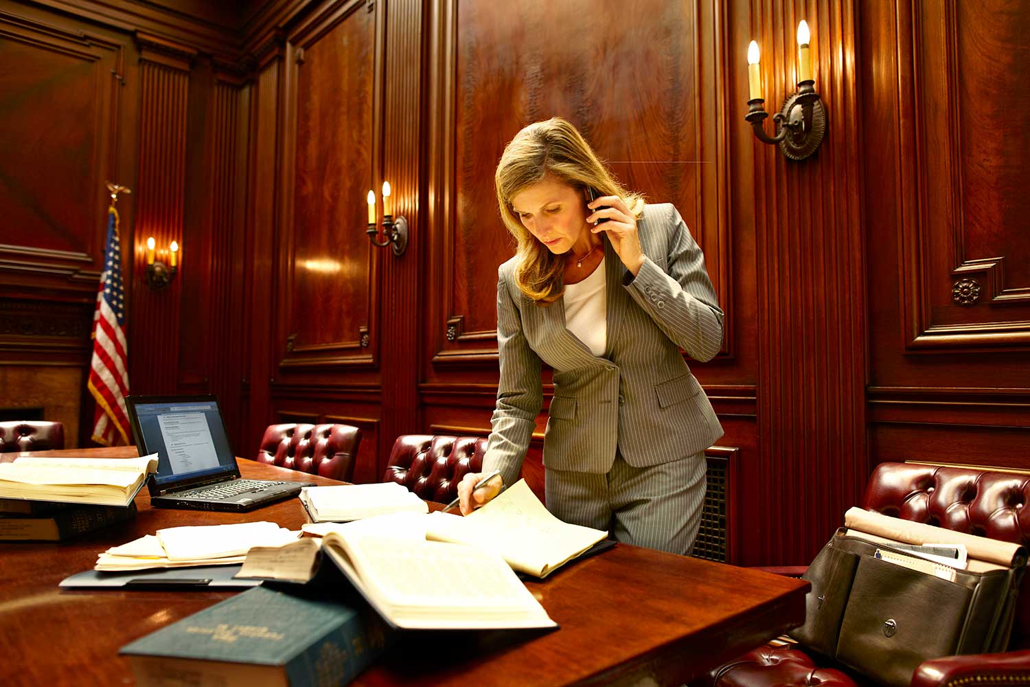 Attorney talks on the phone and examines folders