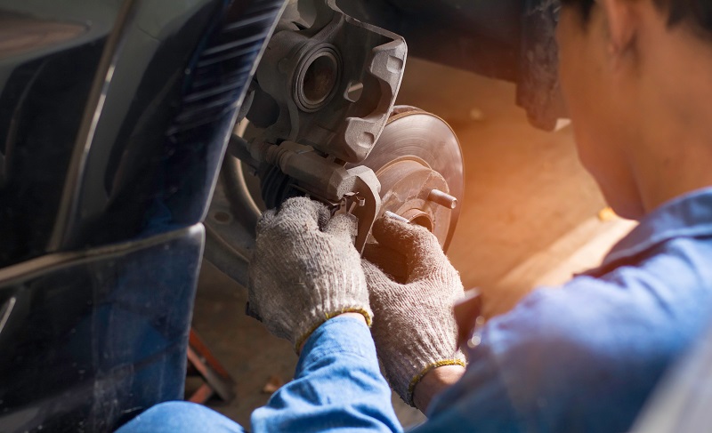 Auto Mechanic working on a car