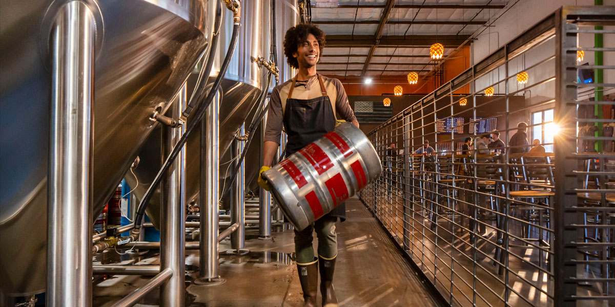 Brewer carrying a keg