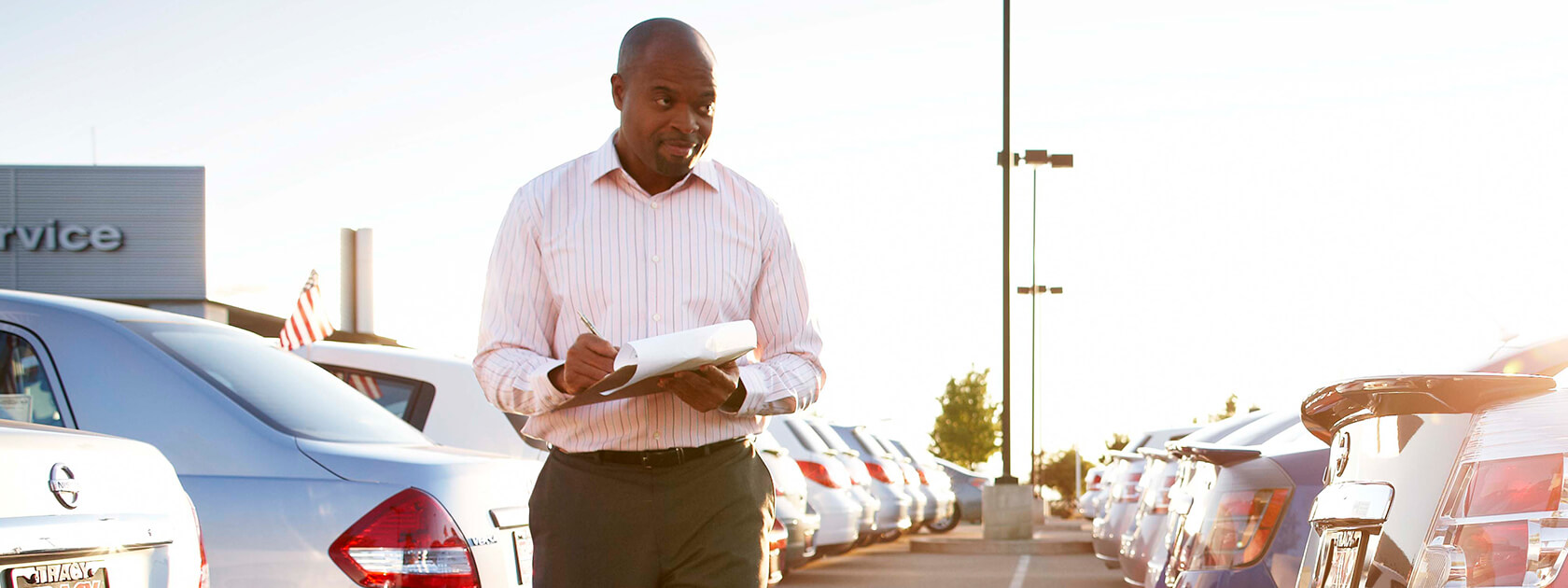 Car dealer checking inventory