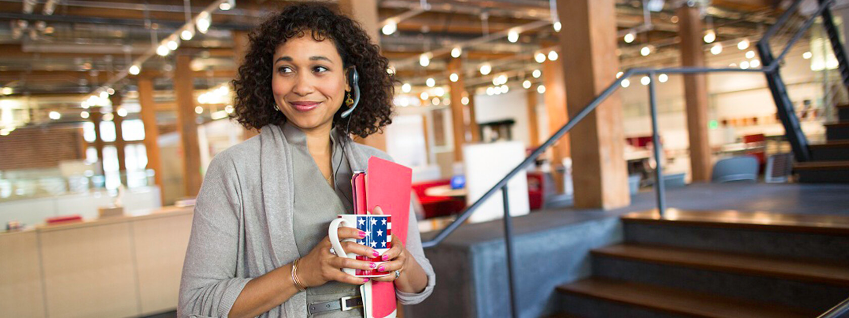 Office employee with headset and coffee