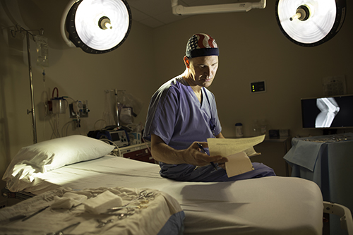 Surgeon examining paperwork, tips to avoid fraudulent claims