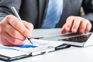 Business person writing in notebook